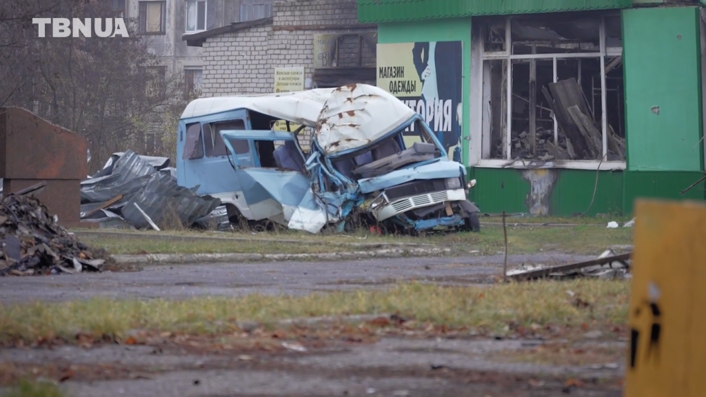 Зруйнований автобус і хати